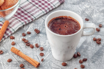 Coffee with cream and freshly baked puffs on a gray background