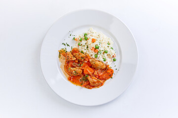 chicken with barley on teh white plate