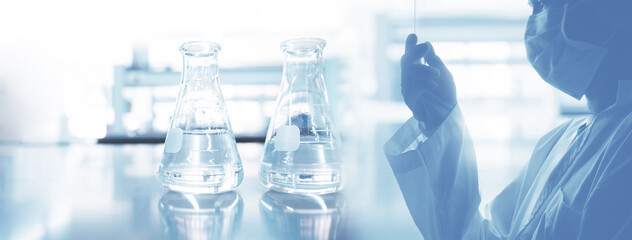scientist in laboratory coat and two glass flask experimental in health science and technology blue banner background