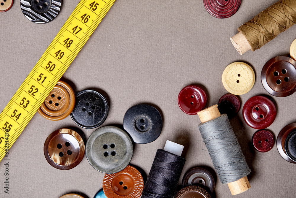Aufkleber background and texture of multicolored antique buttons and sewing tools