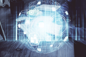 Social network theme hologram with businessman working on computer on background. Multi exposure.
