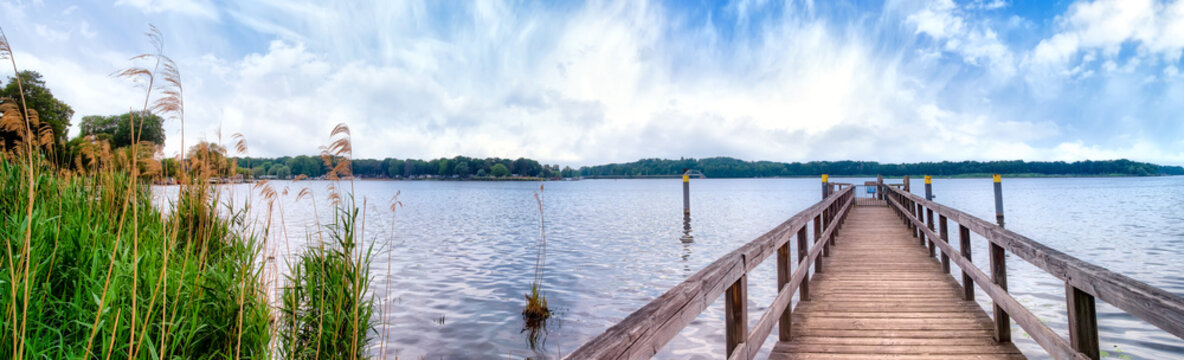 Panoramic view at the Lake Templin with landing stage from the Caputh Palace park , Germany