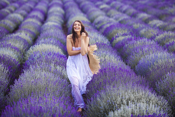 Young woman running in the lavender field. Beautiful woman on summer floral background © olenachukhil