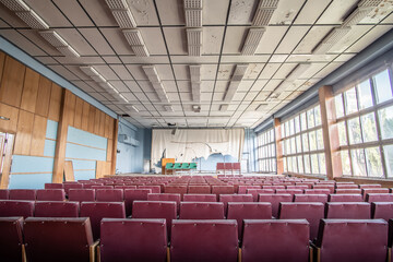 Interrior of abandoned assembly hall in the style of Soviet modernism in a building of the 80s in Eastern Europe.