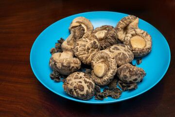Dried Shiitake Mushroom on blue plate. Healthy food menu. Vegetarian food
