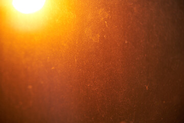 Dirty orange illuminated dusty window texture background