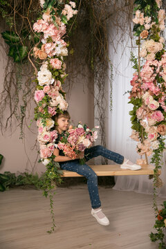 cute Little girl with bouquet of flowers in photo studio