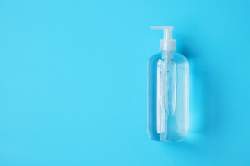 Alcohol hand sanitizer gel bottle on blue background protection against COVID-19 coronavirus. Healthcare and medical concept