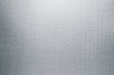 Silver paper texture background. Gray metallic paper sheet surface. Shiny cardboard with smooth gradient reflection