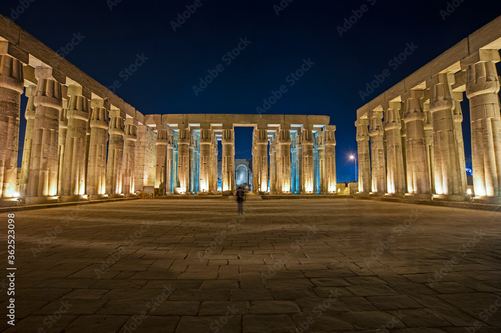 Poster columns in hypostyle hall at luxor temple during night