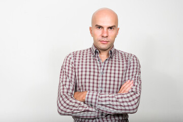 Fototapeta premium Portrait of bald businessman with arms crossed