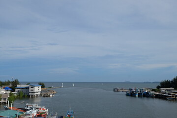 Fototapeta na wymiar The view from the bridge overlooks the fishing communities of Rayong, the river and the Gulf of Thailand.