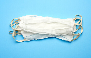reusable mask of white cotton gauze on a blue background