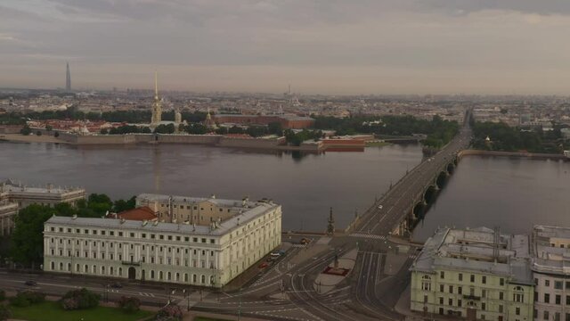 Peter and Paul Fortress in St. Petersburg on a cloudy morning. Span over the Neva River and Trinity Bridge. View from the drone. Russia.