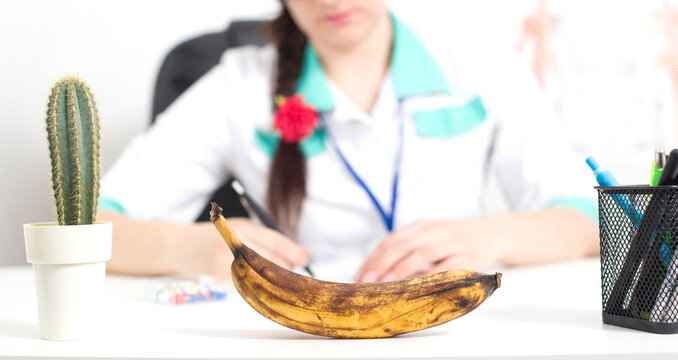Black banana in the foreground in the office of a doctor of a sex therapist. 