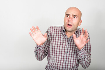 Fototapeta premium Portrait of stressed bald businessman looking scared