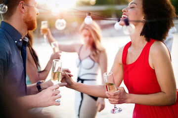 Group of happy people or friends having fun at party