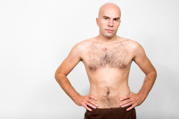 Portrait of bald man shirtless with hair on chest