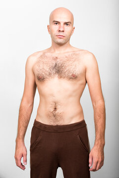Portrait of bald man shirtless with hair on chest