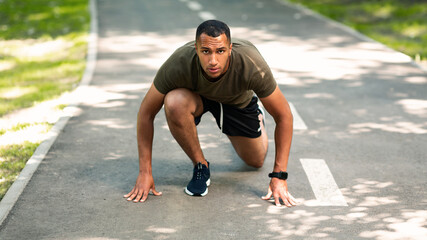 Serious black sportsman ready to run marathon race at park