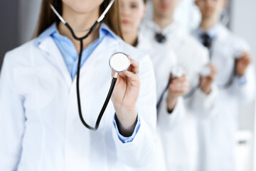 Group of doctors holding stethoscope head close-up. Physicians ready to examine and help patient. Medicine concept