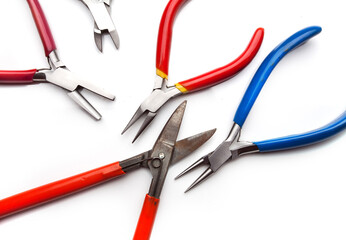 Different goldsmiths tools on the jewelry workplace. Desktop for craft jewelry making with professional tools. White background. 