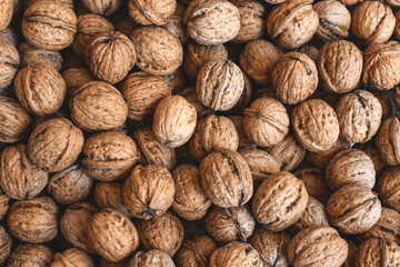 Lots of walnuts top view, texture and background of walnuts, selective focus