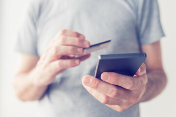 Mobile banking, man using credit card and smartphone app