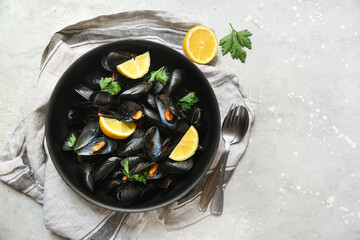 Delicious seafood mussels with lemon and parsley dish on grey background. the view from the top. flat Ley food recipe