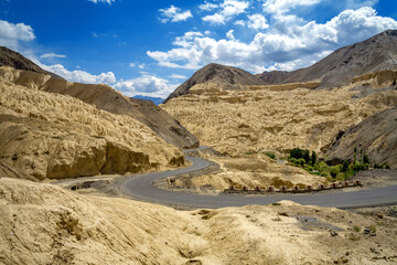 Fototapeta na wymiar Mountain road and moon land (Moonland) view of Lamayuru at Ladakh, Jammu and Kashmir, India
