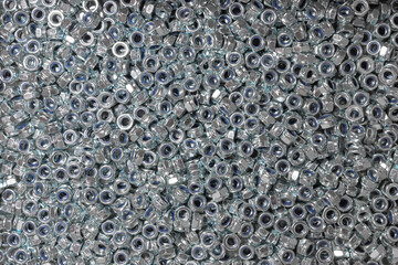 Nuts. Texture. A lot of rubberized nuts for bolts and screws. Background for wallpaper. Female screw. Screw-nut. Internal screw.
