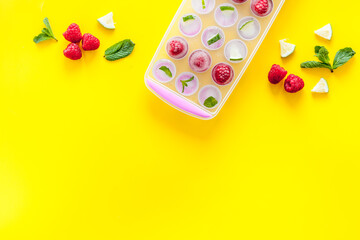 Ice cubes with berries and mint top view copy space
