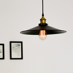 Black ceiling lamp with decorative light bulb