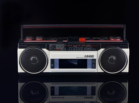 Vintage boom box on black background with reflection