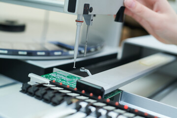 microchip semiconductor manufacturing. operator with machine robot installing chip on board.
