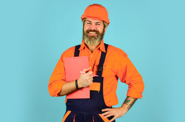 man in overalls. Structural plan safety. work operation concept. looking project folder. blueprint in folder. make notes in clipboard. portrait of engineering man. construction worker holding folder