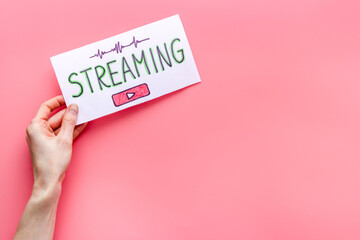 Live streaming web network concept. Female hands holding paper tablet. Top view