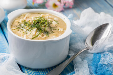 Tasty mushroom soup with noodles on a wooden table.