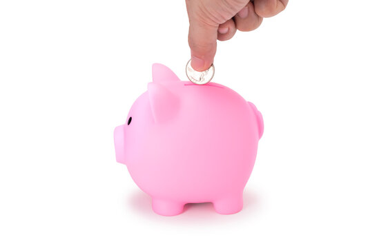 Saving money in pig doll bank isolate on white with clip path, best for die cut. Side view of hand putting coin into pink piggy bank for save money real photo image on white background.