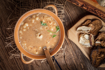 Mushroom soup on a wooden table.