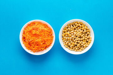 Vegetarian bowl with chickpeas and vegetables - blue table top view