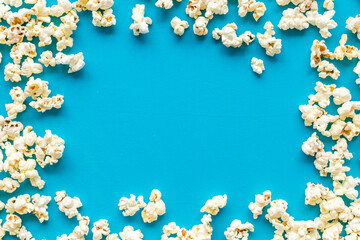 Popcorn mockup on blue background top view copy space