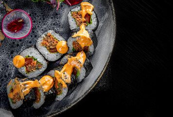 sushi roll in plate on black wooden table background
