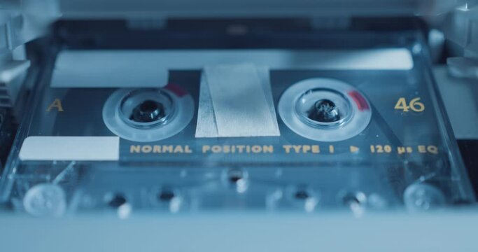 Close up of audio cassette tape playing in stereo / tape recorder