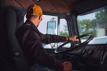 Trucker in His 40s Inside Vintage Aged Semi Truck Tractor Cabin