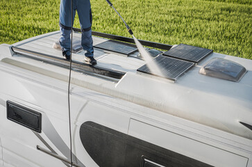 RV Industry Worker Cleaning Camper Van Roof and Motorhome Solar Panels