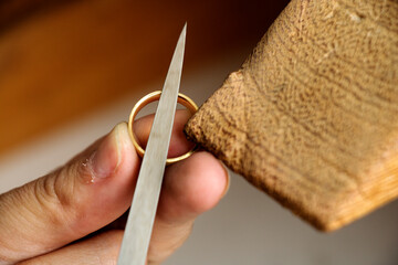 Different goldsmiths tools on the jewelry workplace. Desktop for craft jewelry making with...