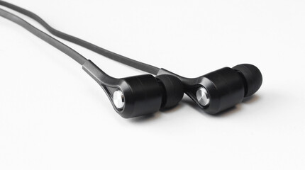 Black earphones close-up. Plastic headphones on white background