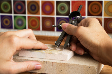 Goldsmiths tools on the jewelry workplace. Tools over rustic wooden background.