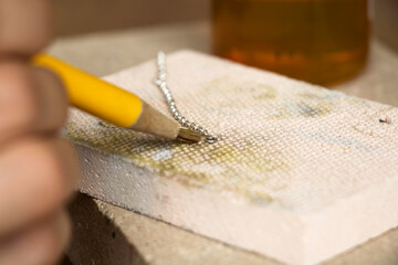 Goldsmiths tools on the jewelry workplace. Tools over rustic wooden background.